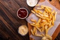 French fries chips potato and sauces on wooden background. top view Royalty Free Stock Photo