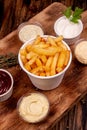 French fries chips potato and sauces on wooden background. top view Royalty Free Stock Photo