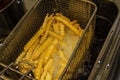 French fries in a deep fryer closeup. Background Royalty Free Stock Photo