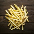 French fries displayed enticingly over a rustic wooden background Royalty Free Stock Photo