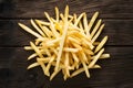 French fries displayed enticingly over a rustic wooden background Royalty Free Stock Photo