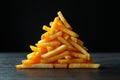 French fries forming a perfect pyramid on a dark background, creating a visually appealing composition Royalty Free Stock Photo