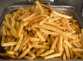French fries fresh cooked. Restaurant deep fryer, metal container with lots of potatoes fried. Street food, fast food.