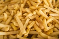 French fries fresh cooked. Restaurant deep fryer, metal container with lots of potatoes fried.