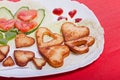 French fries and fresh vegetables chopped in the shape of a heart. Royalty Free Stock Photo