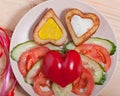 French fries and fresh vegetables chopped in the shape of a heart. Royalty Free Stock Photo