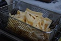 French fries in the fryer, ready to be plunged in oil