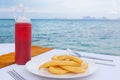 Ocean view restaurant. French fries on with ketchup on table in ocean view Royalty Free Stock Photo
