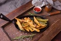 French fries with ketchup on wooden background. Close up