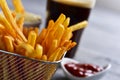 French fries in a metal basket and a soda