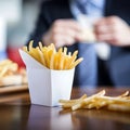 French Fries in a Paper French Fry Carton With a Man in a Suit Cleaning His Fingers