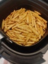 French fries potatoes in fryer closeup