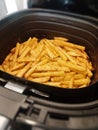 French fries potatoes in fryer closeup