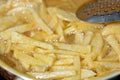 French fries potatoes frying in boiling hot oil in a deep fryer at home. French fries, Junk food concept Royalty Free Stock Photo