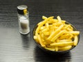 French fries and salt shaker on the table.