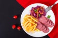 French fries and sliced smoked meat with cabbage salad Royalty Free Stock Photo