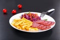 French fries and sliced smoked meat with cabbage salad Royalty Free Stock Photo