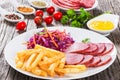 French fries and sliced smoked meat with cabbage salad Royalty Free Stock Photo