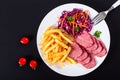 French fries and sliced smoked veal with cabbage salad Royalty Free Stock Photo