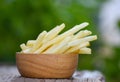 French fries in wooden bowl delicious Italian meny homemade ingredients on table nature green background - Tasty potato fries for Royalty Free Stock Photo