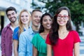 French girl with male and female young adults in line