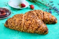 French grain croissants and a cup of tÃÂµÃÂ°, strawberry jam on a bright background.