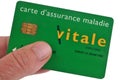 French health insurance card in hand on white background