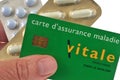 French health insurance card in hand with blister packs of drugs in the background