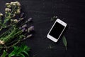 French herbs and phone on the black desk