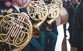 French horn and child hands. Musical brass instruments, adults and children. Concert in the school Royalty Free Stock Photo