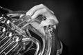 French horn instrument. Hand playing horn player Black and white image Royalty Free Stock Photo