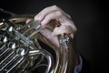 French horn instrument. Hand playing horn player Royalty Free Stock Photo