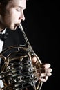 French horn player. Hornist playing brass instrument Royalty Free Stock Photo