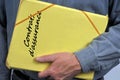 French insurance contracts folder in hand in hand in close-up