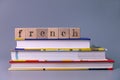 French language course and learning concept. stack of books with wooden blocks