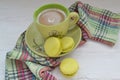 French macaron, the famous pastry, green macarons with green cup of coffee on shabby rustic background