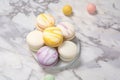 french macarons in pastel colors on marble surface