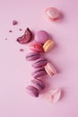 French macarons on pink background.