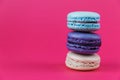 French macarons. Sweet colorful bisquits. Front view. Copy text space. Hot pink background. Royalty Free Stock Photo