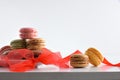French macaroons gift presentation with red bow on white background