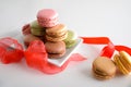 French macaroons gift presentation with red bow on white table