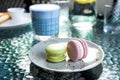 French macaroons on a gray plate. Matcha blue tea