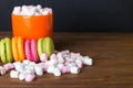 French macaroons and marshmellow in dark wooden background