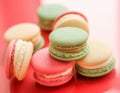 French macaroons on red background, parisian chic cafe dessert, sweet food and cake macaron for luxury confectionery brand, Royalty Free Stock Photo