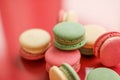 French macaroons on red background, parisian chic cafe dessert, sweet food and cake macaron for luxury confectionery brand, Royalty Free Stock Photo