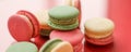 French macaroons on red background, parisian chic cafe dessert, sweet food and cake macaron for luxury confectionery brand, Royalty Free Stock Photo