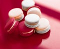 French macaroons on wine red background, parisian chic cafe dessert, sweet food and cake macaron for luxury confectionery brand, Royalty Free Stock Photo