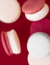 French macaroons on wine red background, parisian chic cafe dessert, sweet food and cake macaron for luxury confectionery brand, Royalty Free Stock Photo