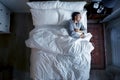 French man sleeping alone on bed Royalty Free Stock Photo