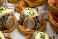 French mini quiche pie with goat cheese and traditional French sausage Andouillette from Troyes in bakery